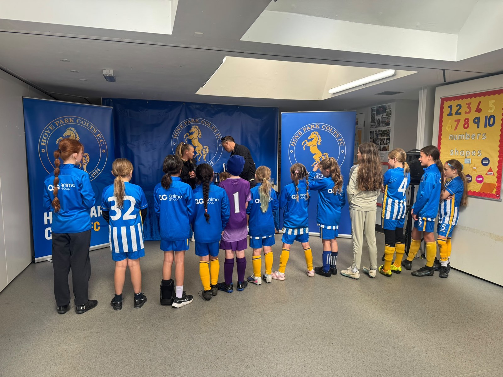 The sponsored girls' squad in their Animo Group branded kit at a club presentation evening